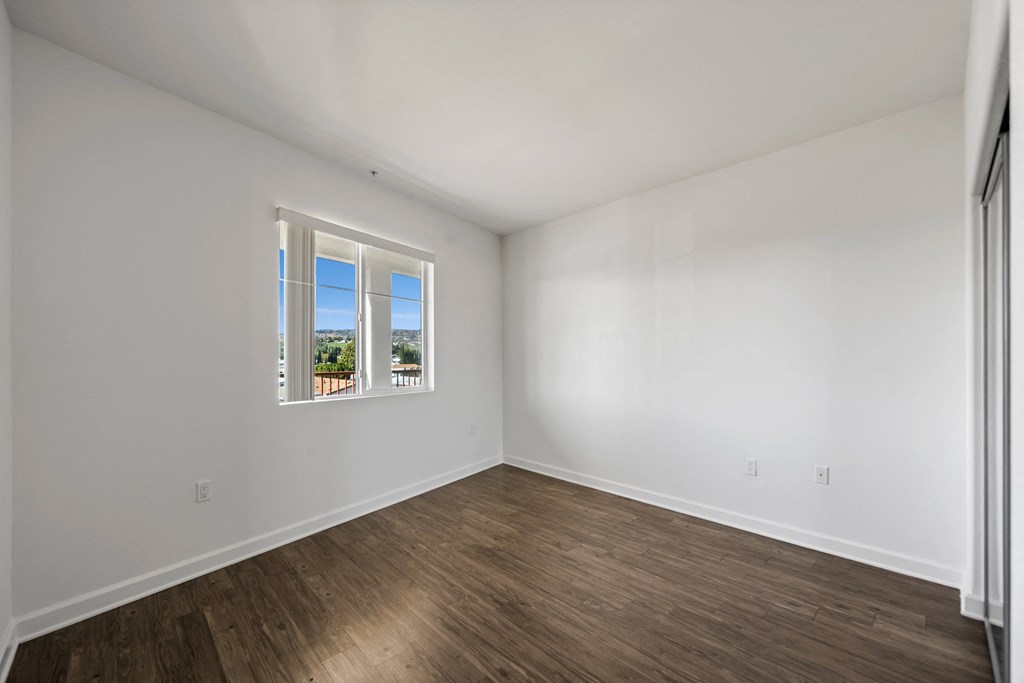 an empty room with white walls and a window