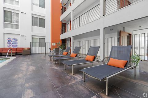 a row of lounge chairs in front of a building