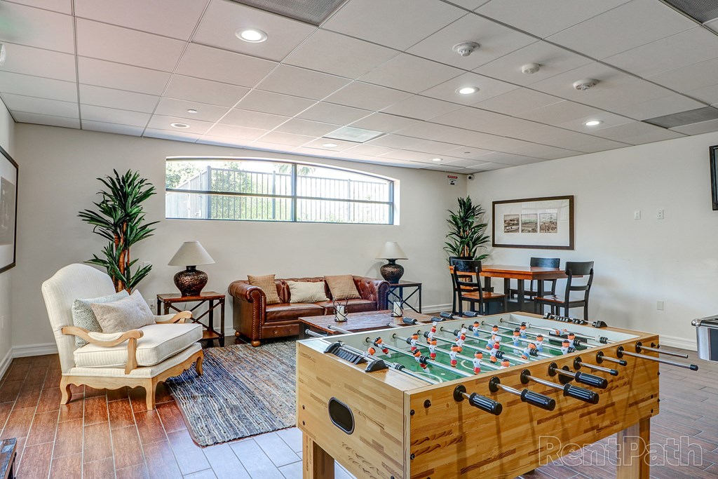 a game room with a foosball table and chairs