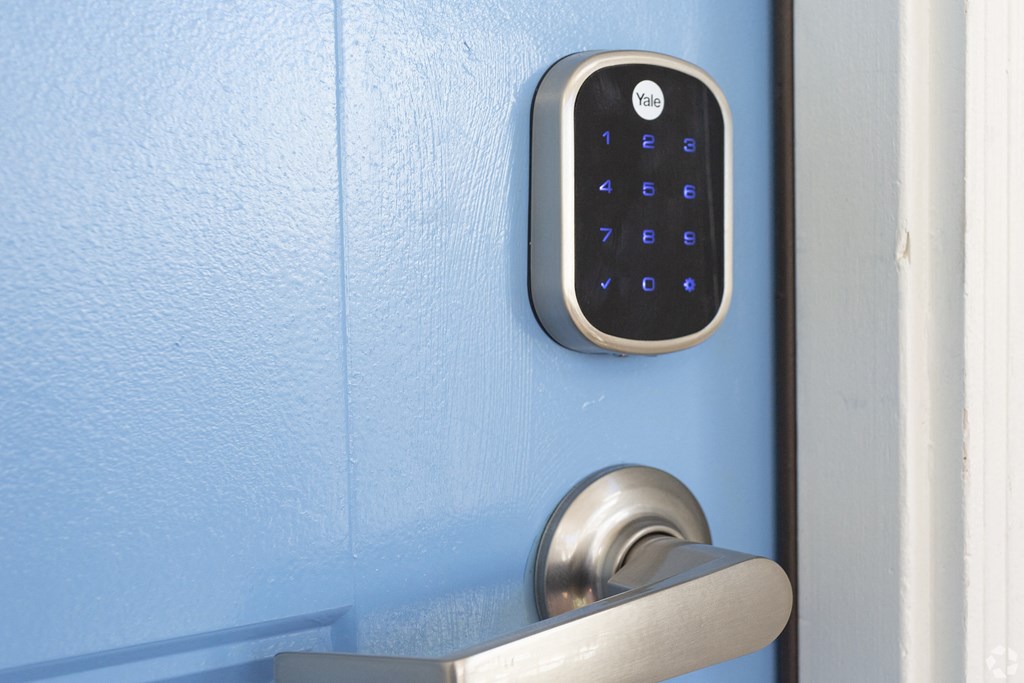 an open door with a digital lock on the door handle