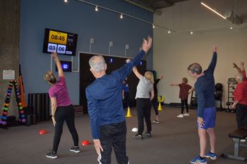 a group of people doing yoga in a gym