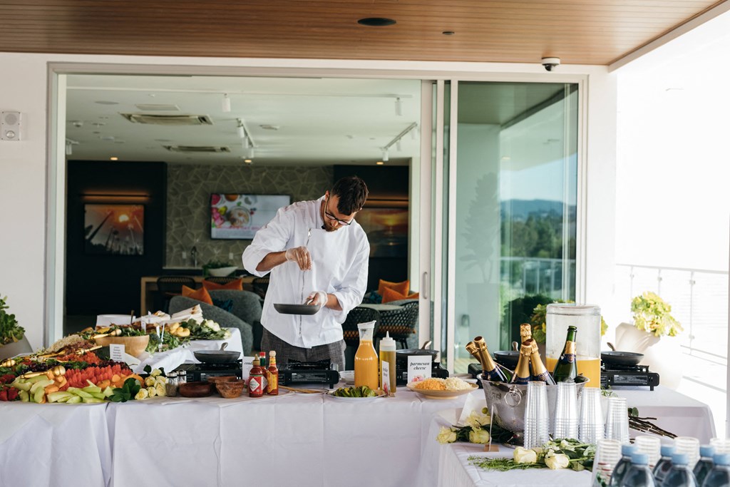 a chef in a kitchen preparing food on a buffet table