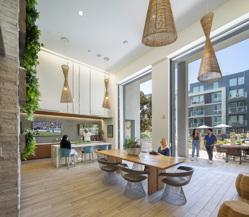 a rendering of a communal area with a dining table and chairs