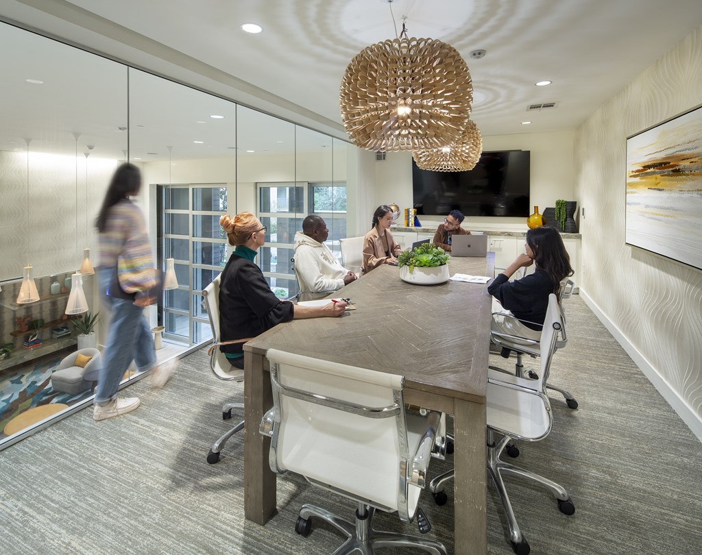 a group of people sitting around a table in an office