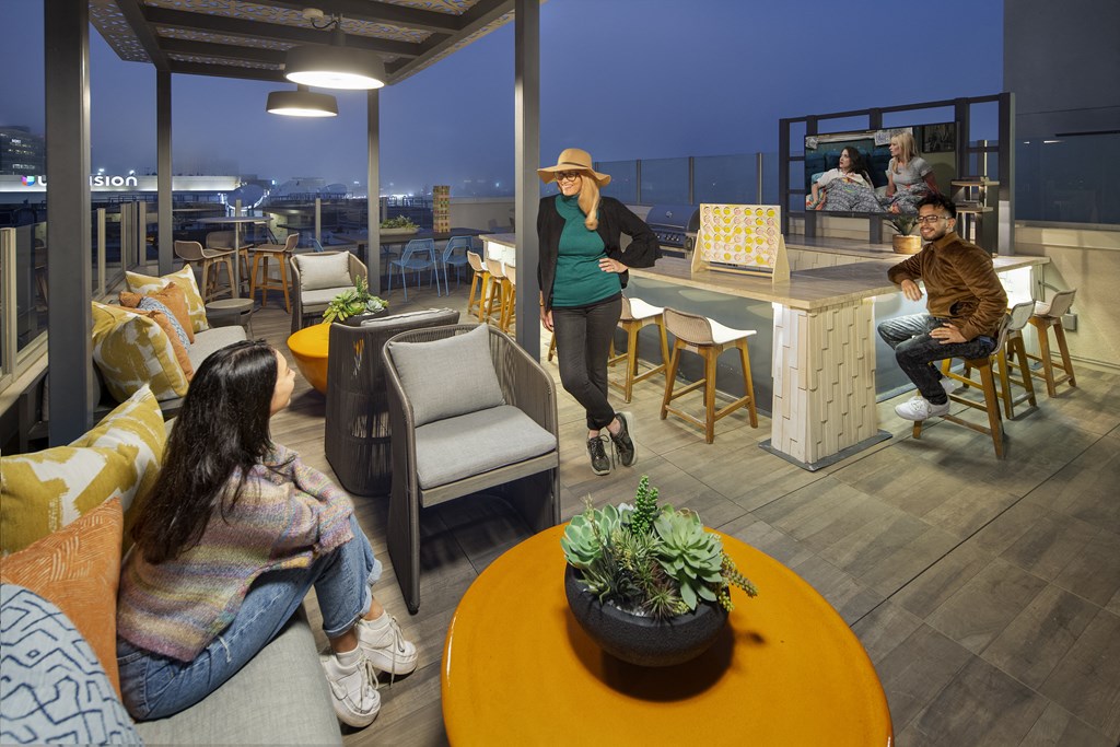 a group of people sitting on top of a building