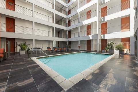 A large indoor swimming pool in a multi-story residential building.