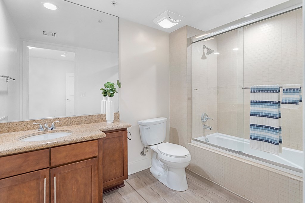 a bathroom with a shower toilet and sink