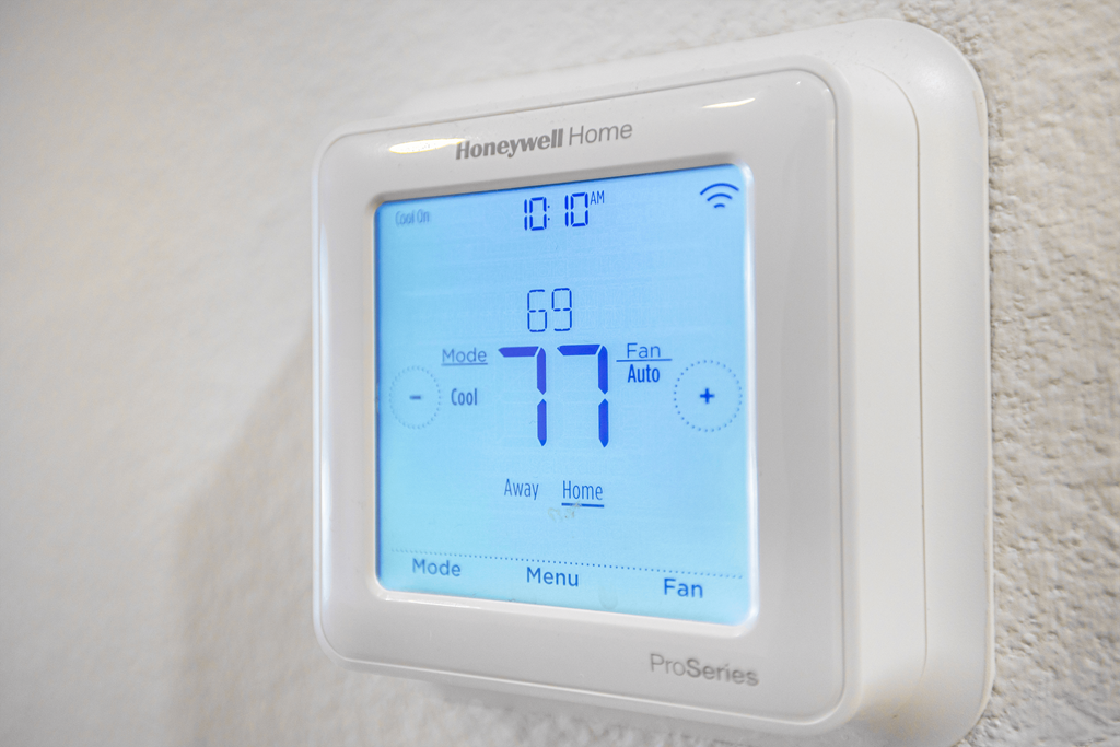A Honeywell Home Pro Series thermostat shows the temperature is 77 degrees.