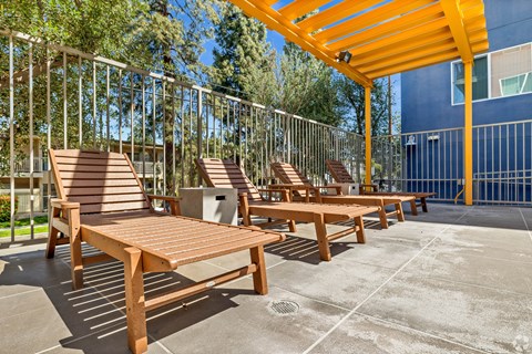 A sunny day at the outdoor seating area with wooden benches and tables.