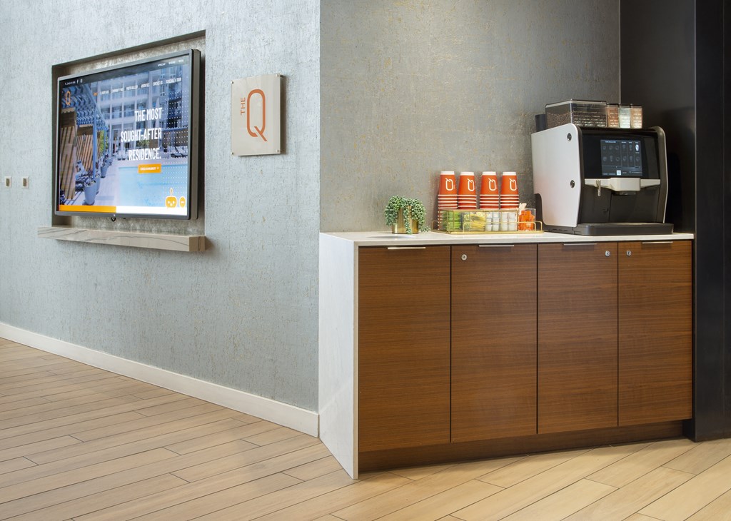 a room with a television and a coffee maker in it