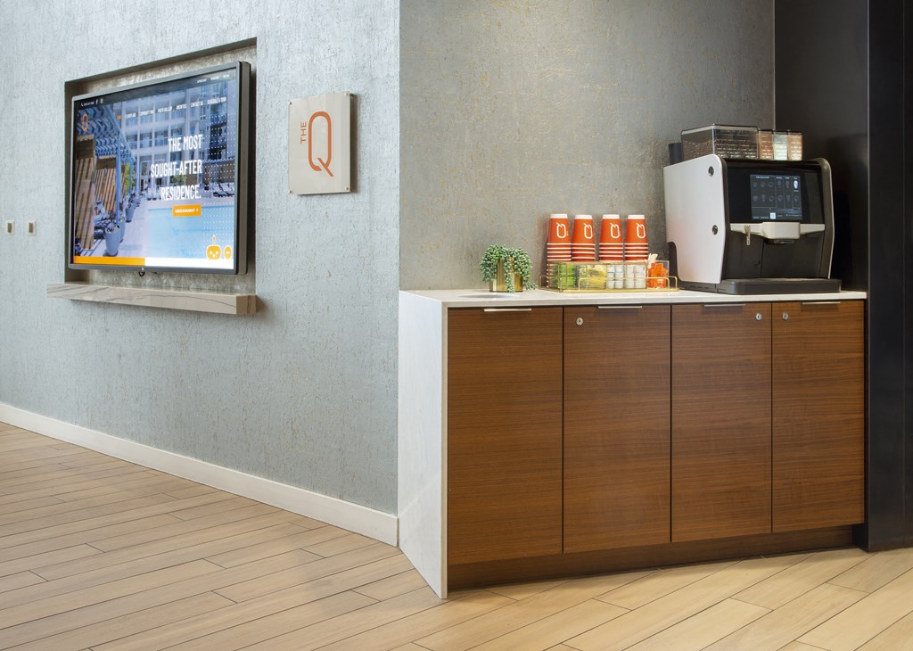 a room with a television and a coffee maker in it