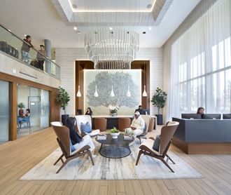 a rendering of a hotel lobby with a large chandelier and people in the background - Photo Gallery 3