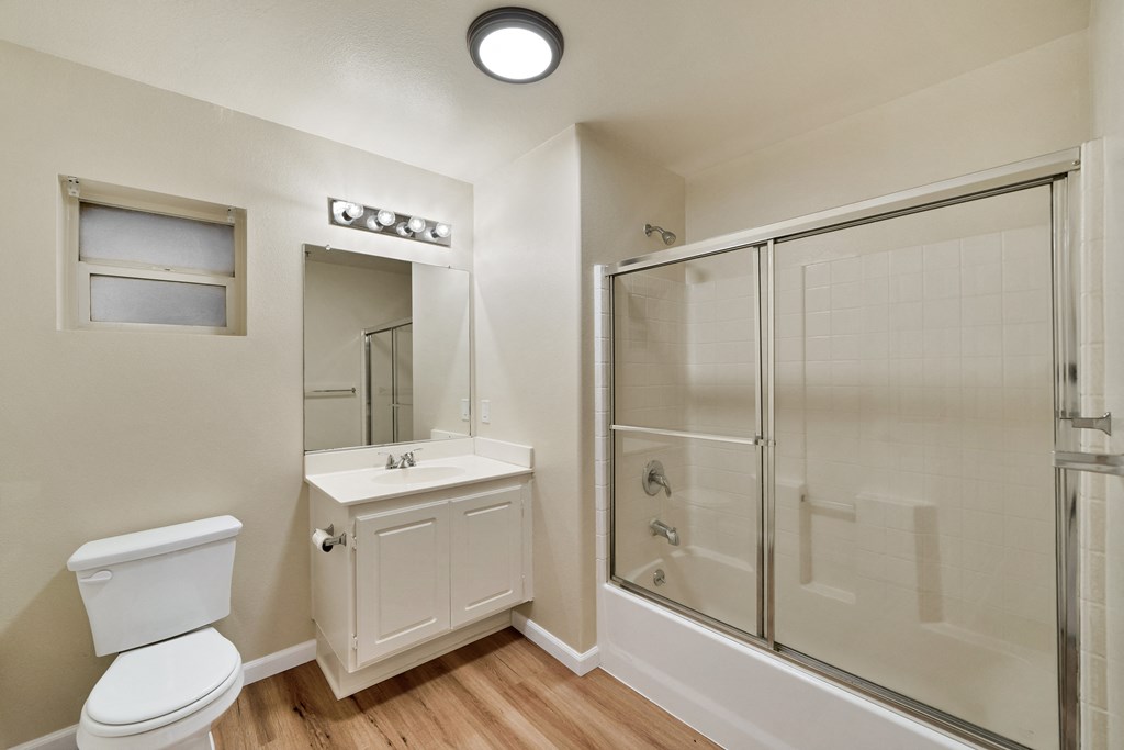 an empty bathroom with a shower toilet and sink