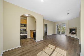 a living room with hardwood floors and a fireplace at The Village Apartments, Van Nuys, 91406 - Photo Gallery 5