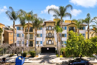 exterior image of a building with palm trees and blue sky at Toscana Apartments, Van Nuys - Photo Gallery 3