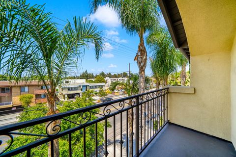 a balcony looking out onto palm trees at Toscana Apartments, Van Nuys, 91406