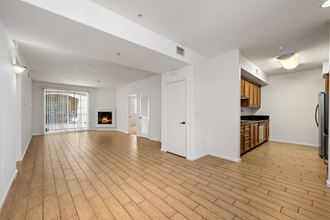 a living room with a fireplace and a kitchen at Le Blanc Apartments, California, - Photo Gallery 2