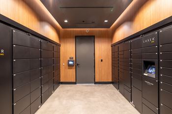 A hallway with lockers and a door at the end.