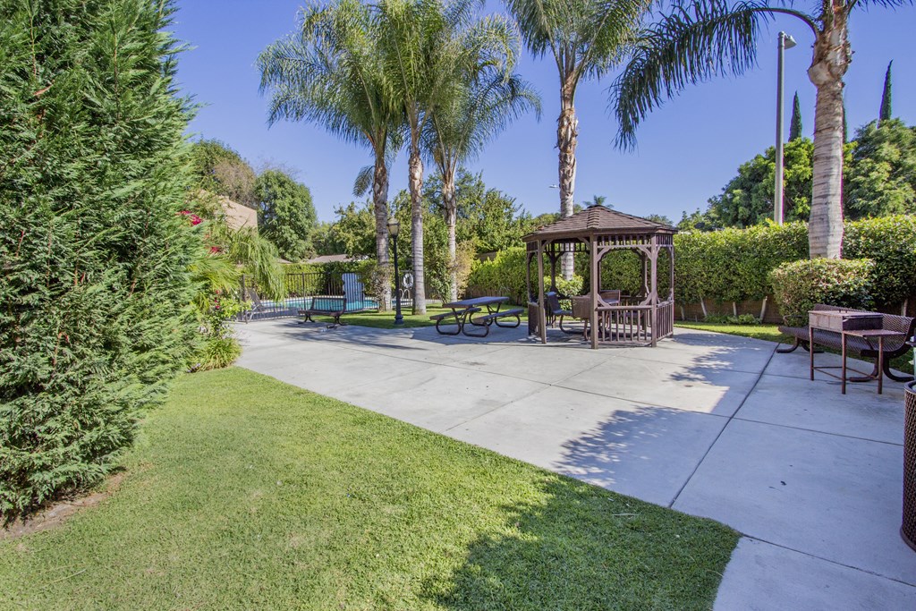 a park with a gazebo and benches and trees