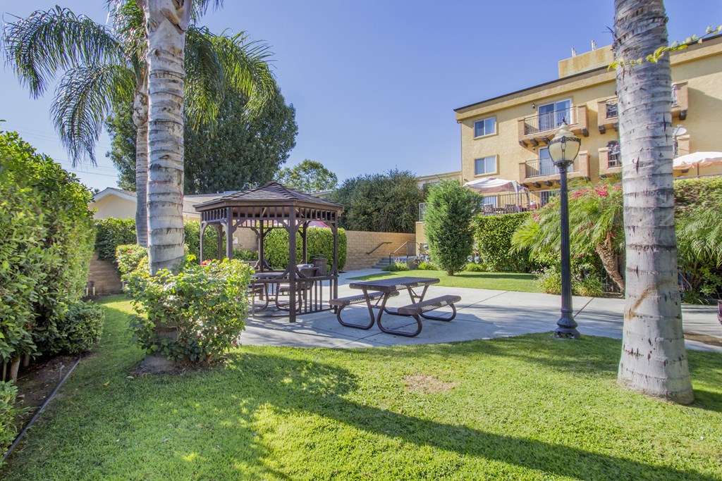 a backyard with a picnic table and a gazebo