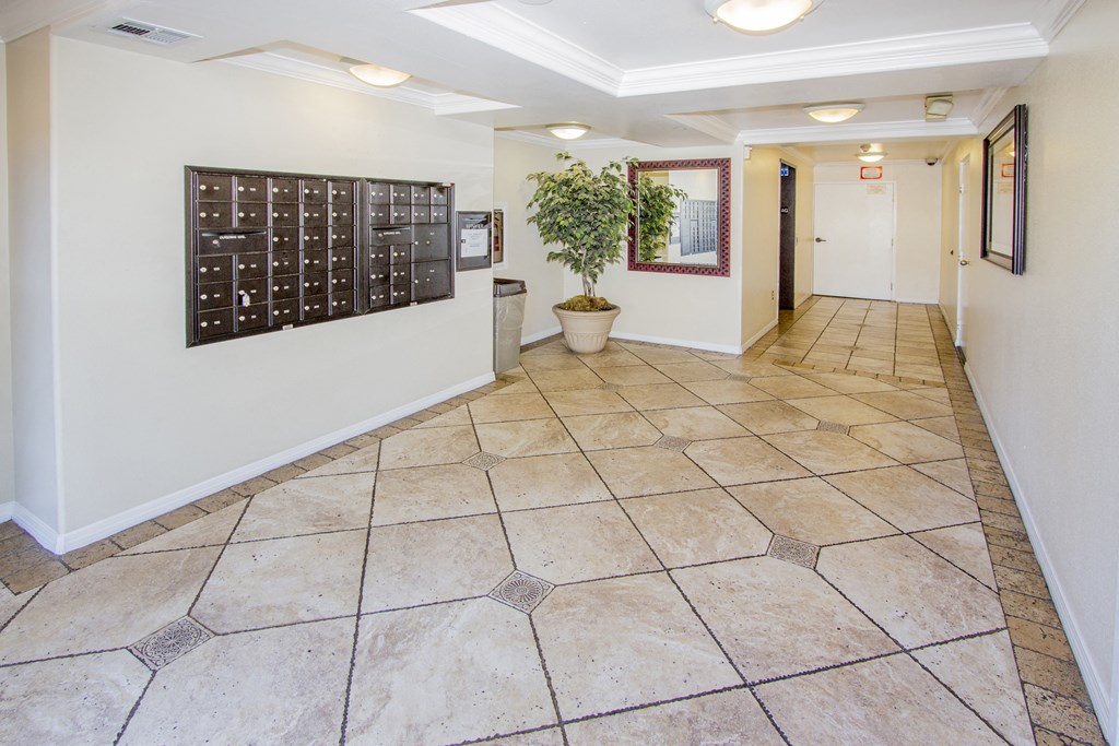 a hallway with tile floors and a calendar on the wall