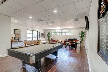 A clubhouse and game room with pool table and foosball