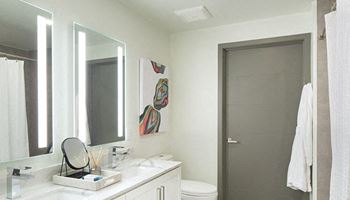 a bathroom with a white sink and a white toilet