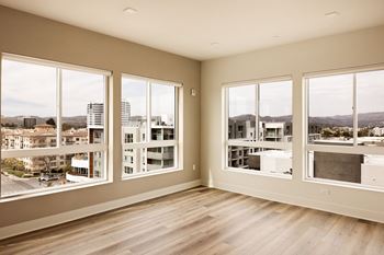A room with large windows overlooking a cityscape.