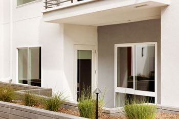 A white house with a black door and windows.