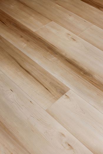 A wooden floor with light brown planks.