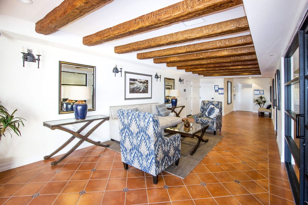 a living room with a couch and chairs and a table at Le Blanc Apartment Homes, Canoga Park, 91304