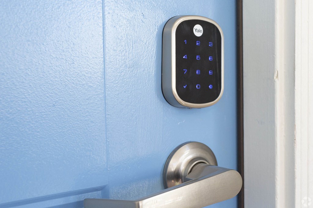 an open door with a digital lock on the door handle at Le Blanc Apartment Homes, Canoga Park, California