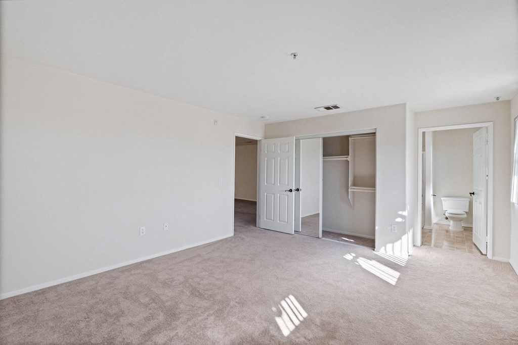 an empty living room with white walls and a bathroom at Dronfield Astoria, Sylmar, California