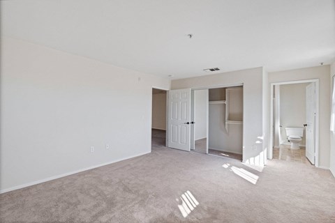 an empty living room with white walls and a bathroom at Dronfield Astoria, Sylmar, California