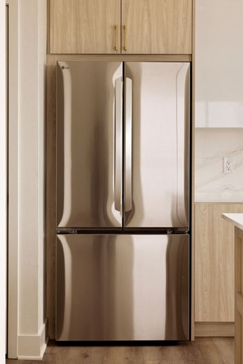 A stainless steel refrigerator with its door open.