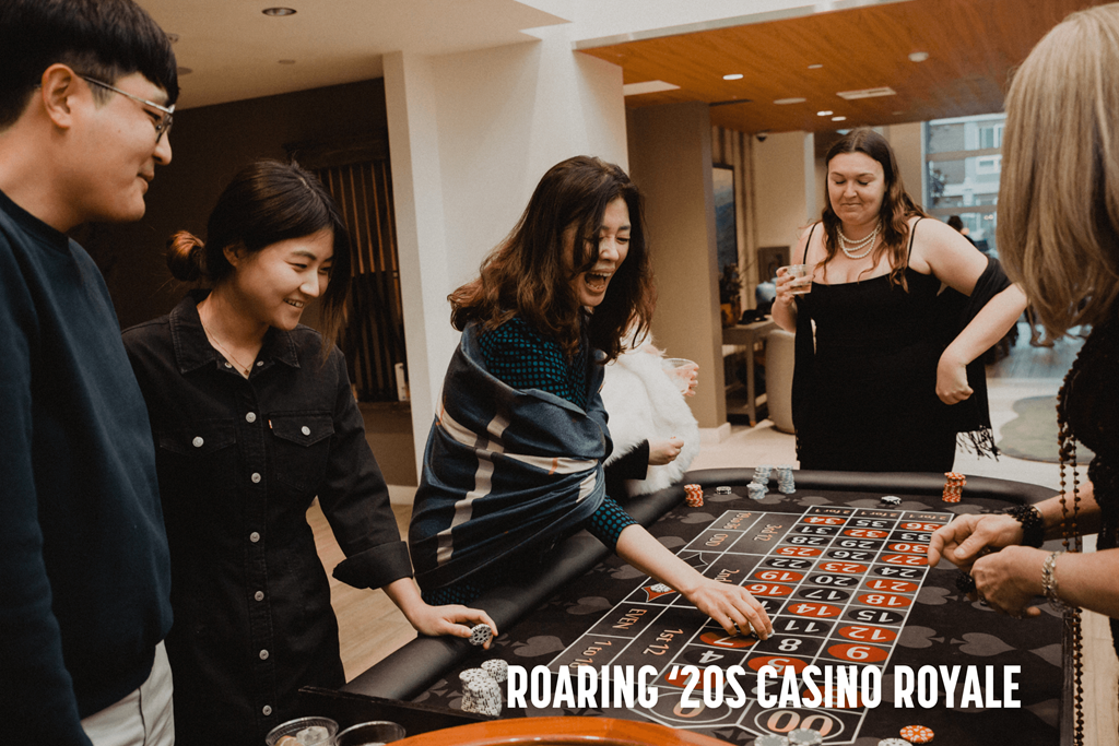 A group of people playing a game of roulette.