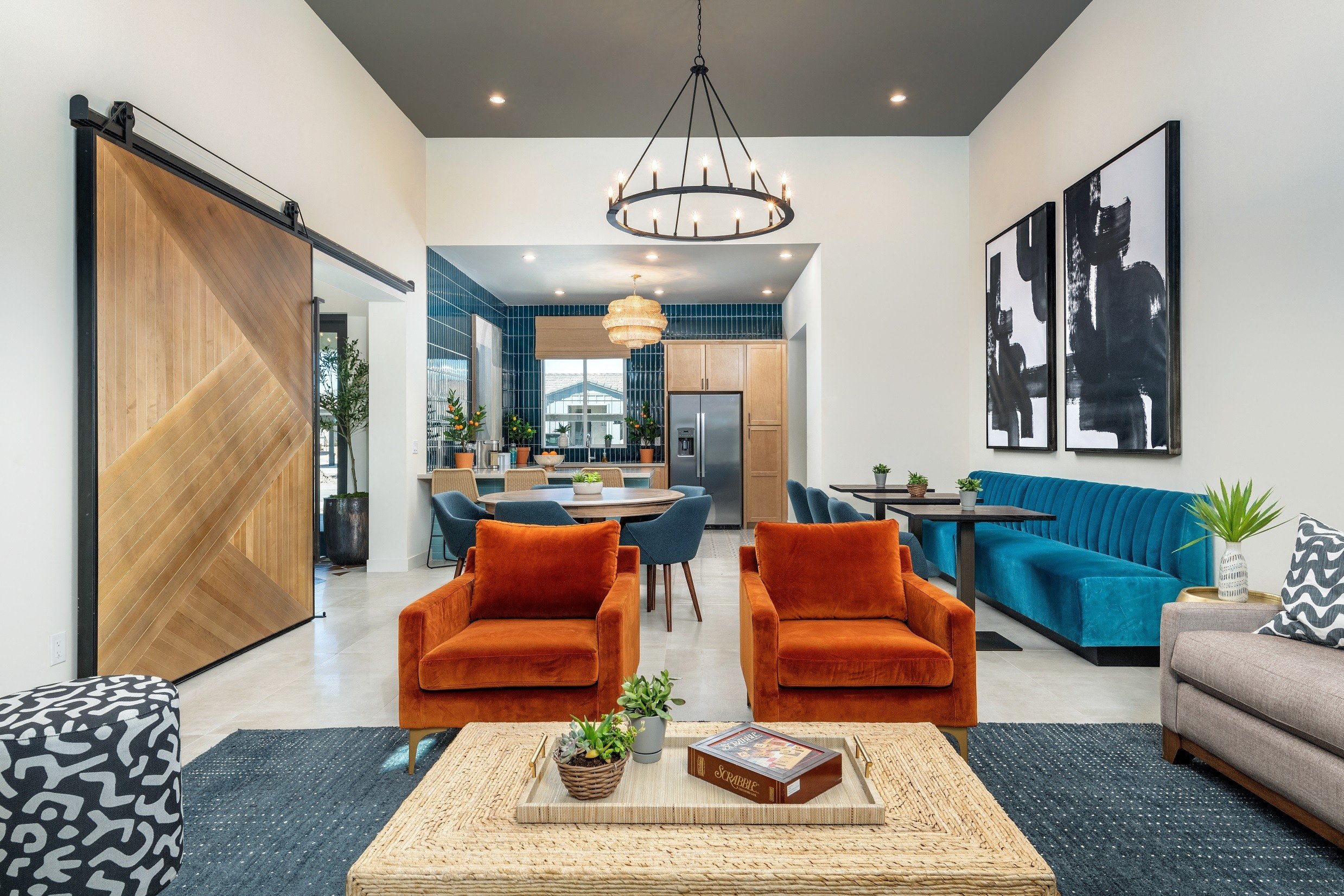 a living room with blue and orange chairs and a table