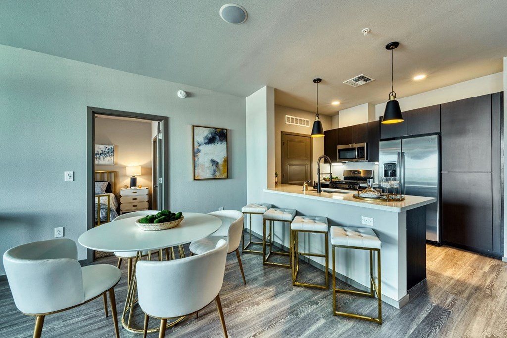 Dining table and chairs with kitchen island at Cuvee, Arizona