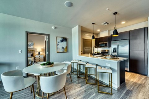 Dining table and chairs with kitchen island at Cuvee, Arizona