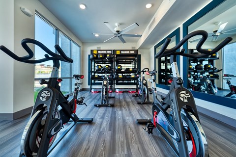Yoga room gym with spin bikes and a ceiling fan at Cuvee, Glendale Arizona