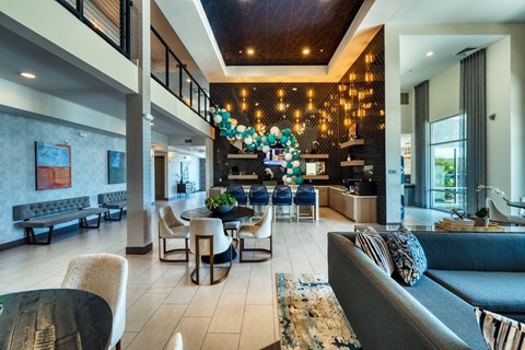 Clubhouse with blue couches and chairs and a bar at Cuvee, Glendale, 85305