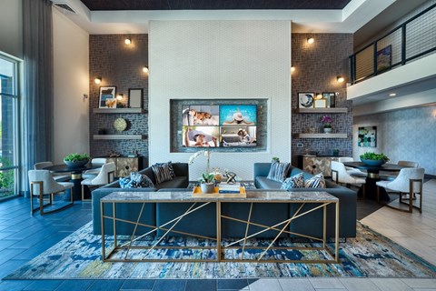 Resident clubhouse with a couch and a table at Cuvee, Glendale, AZ