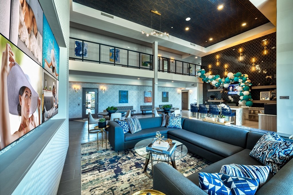 Clubhouse area with blue couches and overhead lighting at Cuvee, Glendale