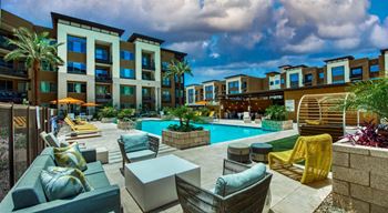 Elevation SanTan swimming pool with lounge chairs and tables in front