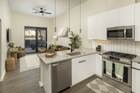 A modern kitchen with a stainless steel dishwasher and oven.