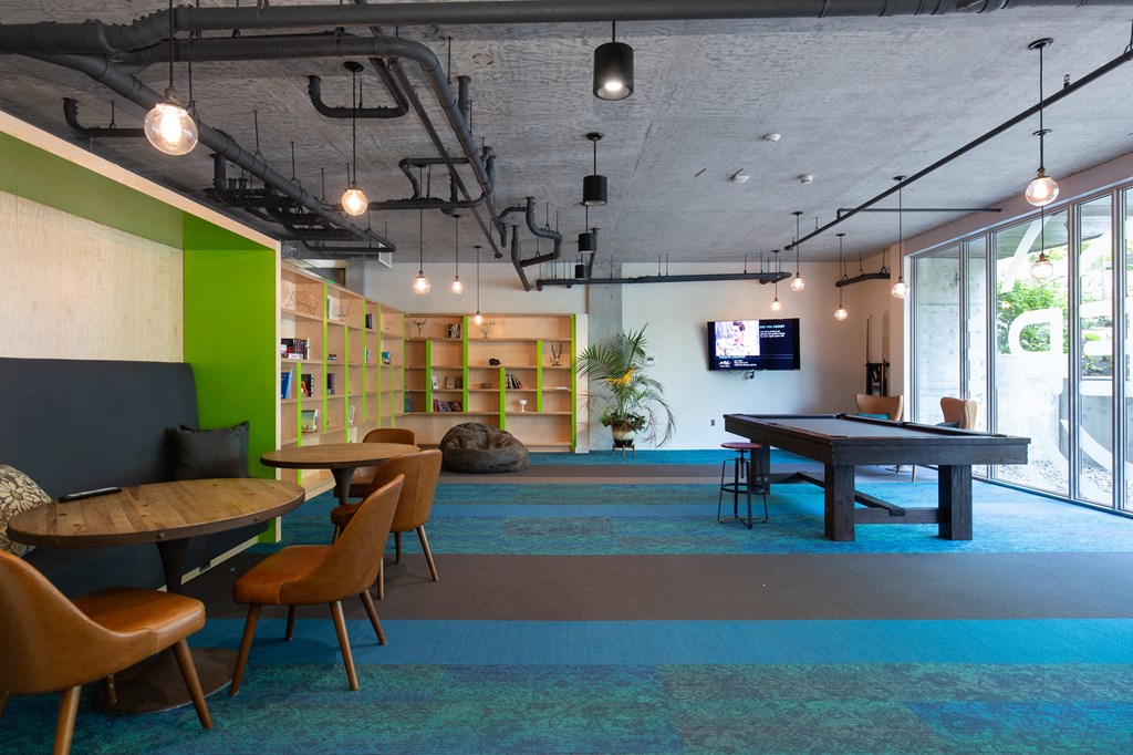 a game room with a ping pong table and a tv