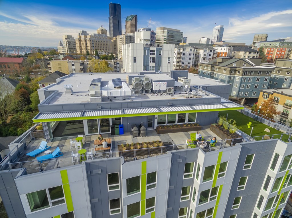 an aerial view of a building with a city in the background