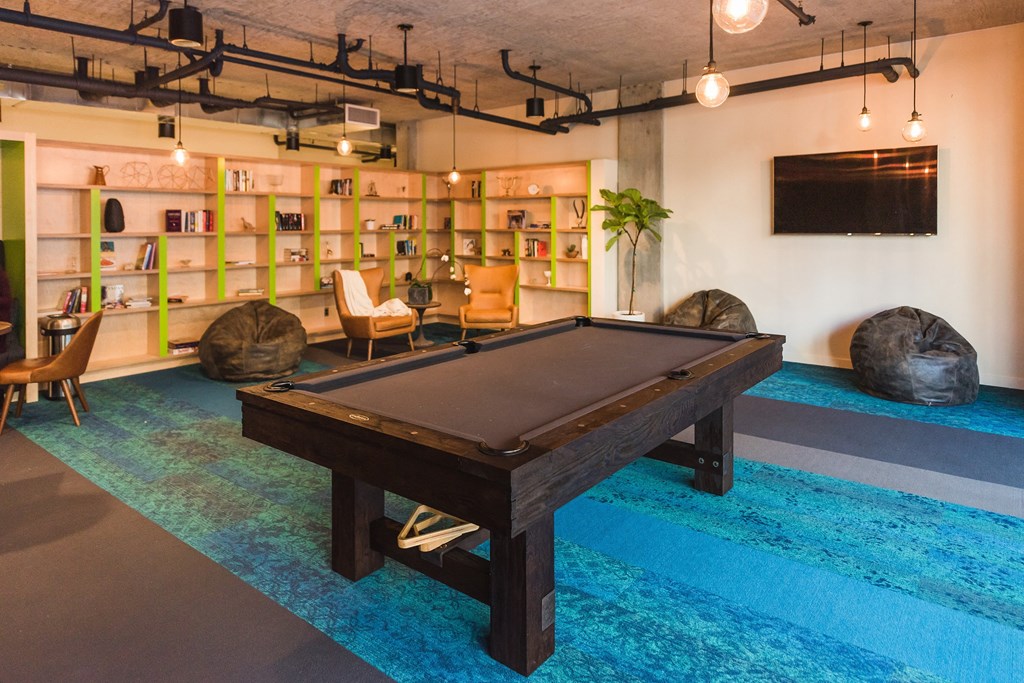 a pool table in a living room with a tv