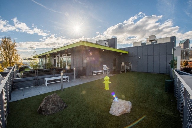 a yellow fire hydrant on the roof of a building