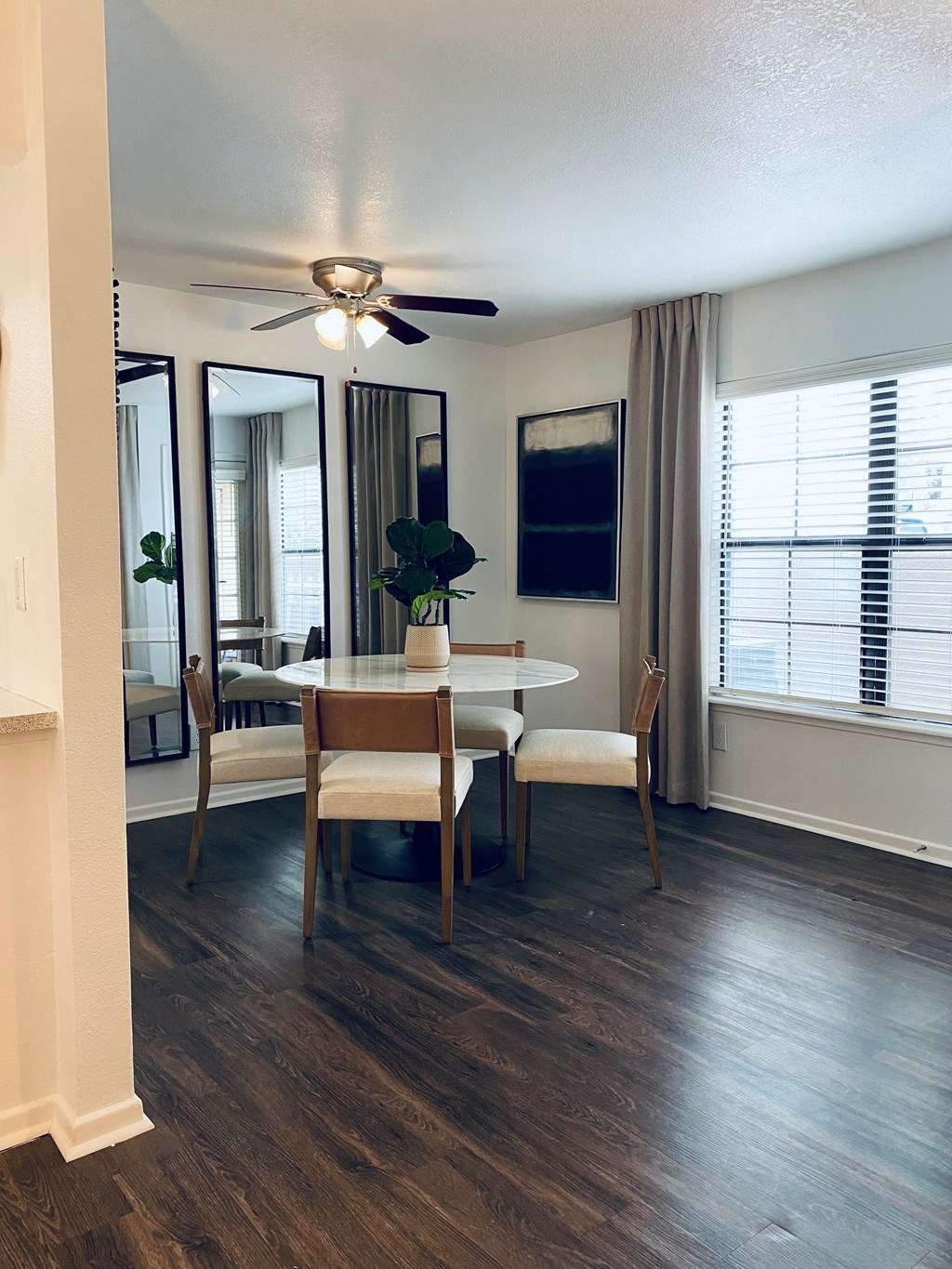 A dining room with a table and chairs.
